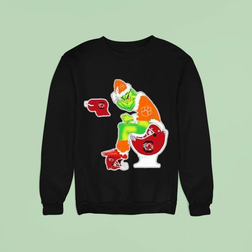 The Grinch Clemson Tigers Sitting On Toilet South Carolina Gamecocks Xmas Holiday Christmas Sweatshirt The Grinch Clemson Tigers Sitting On Toilet South Carolina Gamecocks Xmas Holiday Christmas Sweatshirt